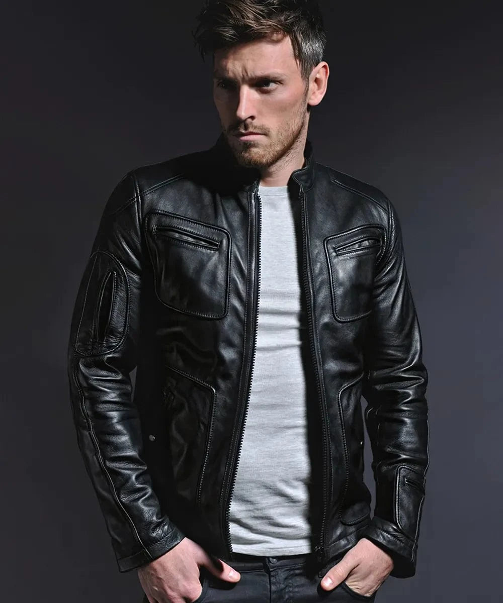 Male model wearing a black leather Kirk jacket with slim fit styling, band collar, zip front, and oversized chest pocket detailing
