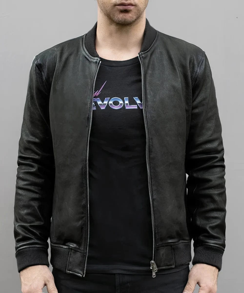 Model wearing vintage black leather bomber jacket with slim fit styling and ribbed knit trim