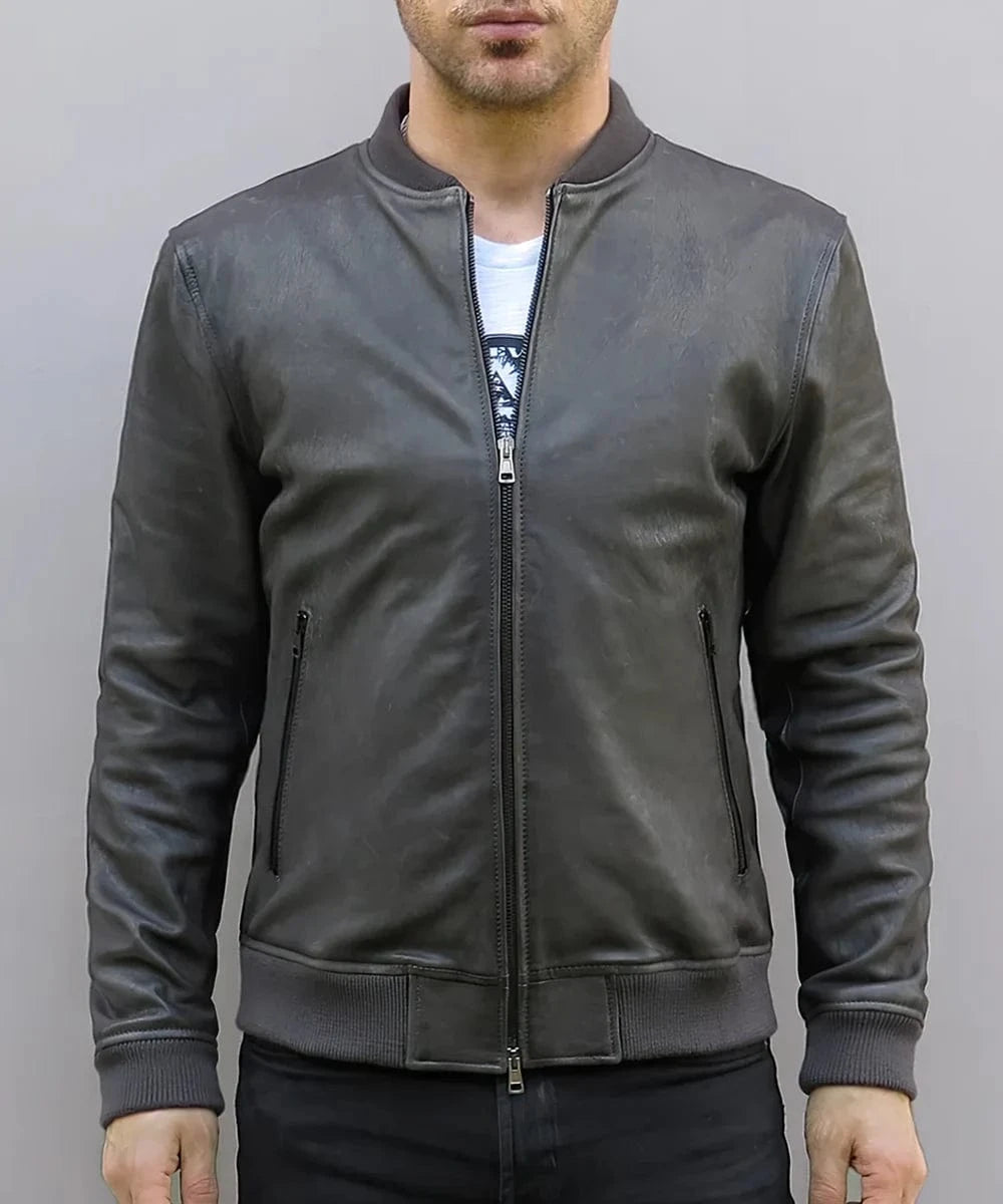 Model wearing vintage grey leather bomber jacket with slim fit styling and ribbed knit trim