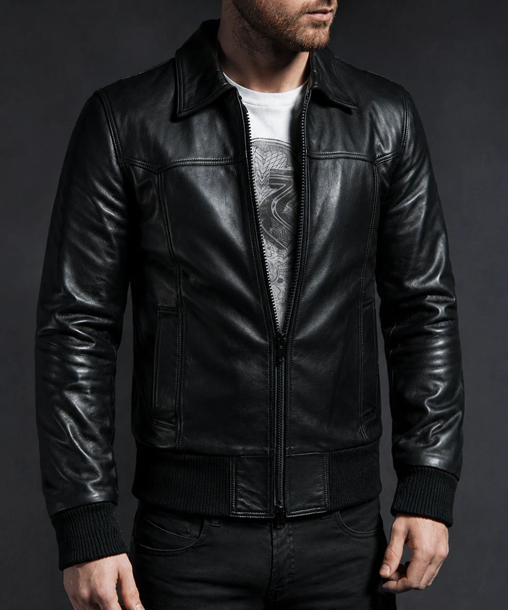 Model wearing vintage black leather bomber jacket with slim fit styling and ribbed knit trim