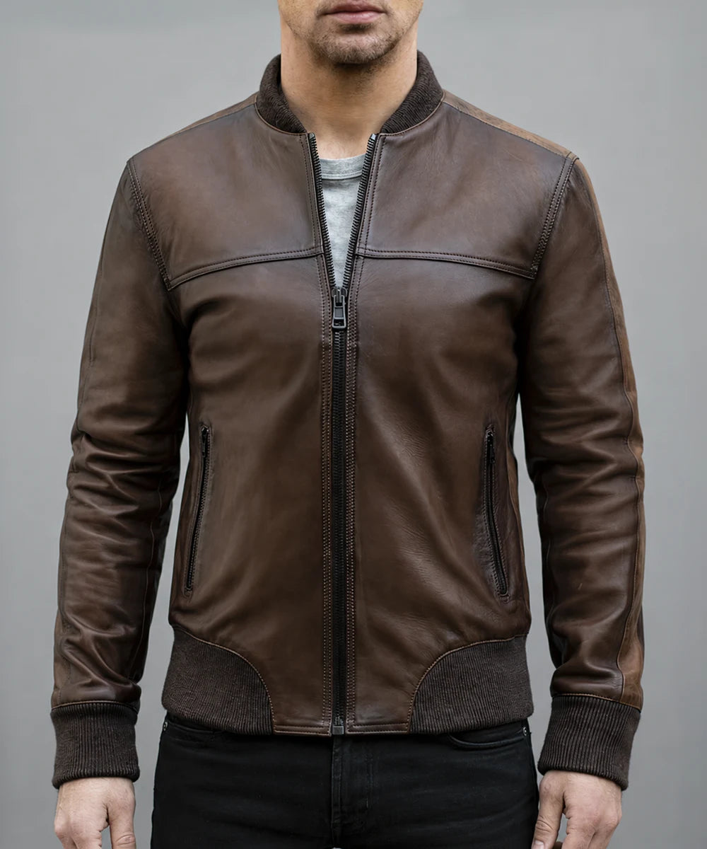 Model wearing vintage brown leather bomber jacket with slim fit styling and ribbed knit trim