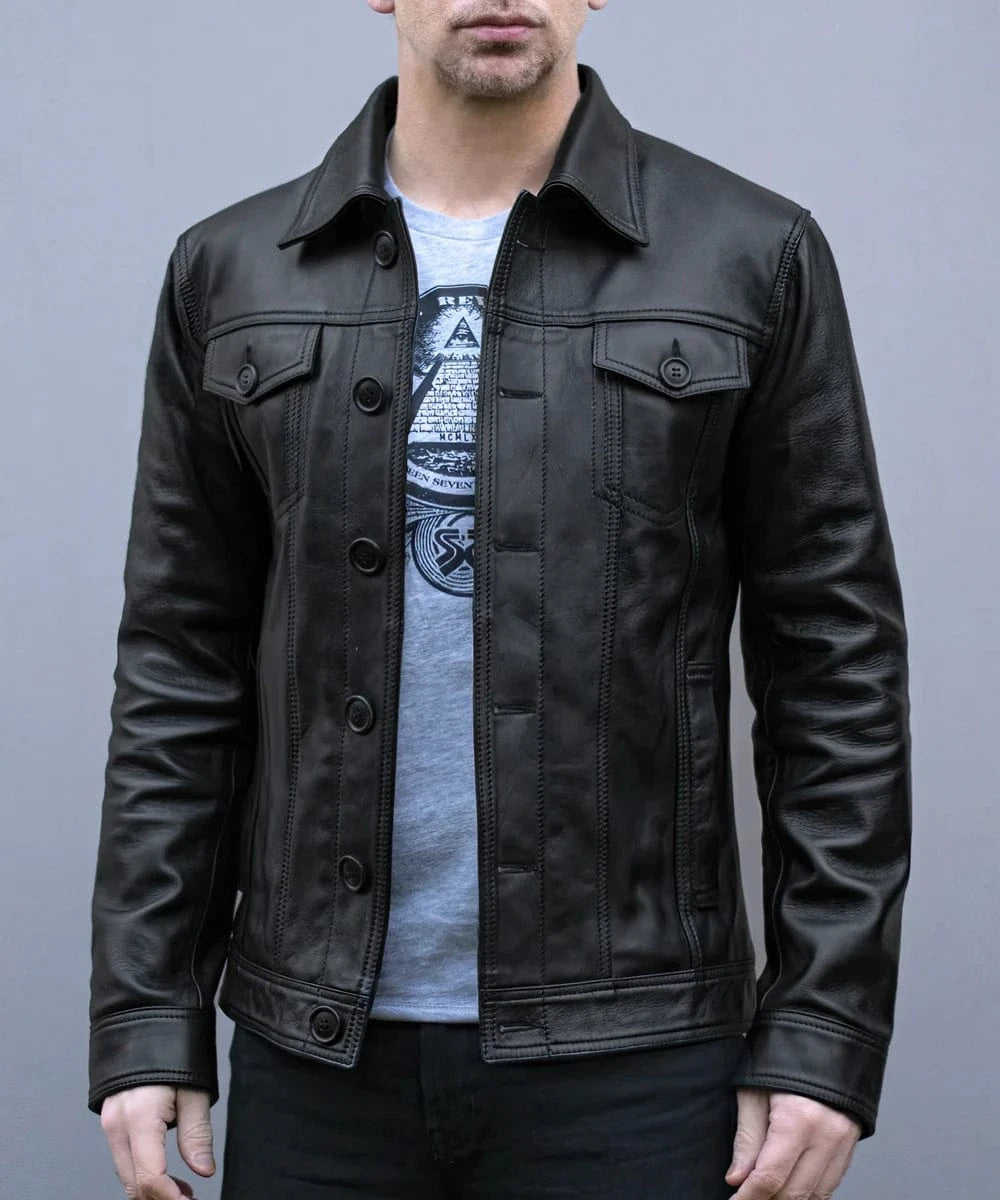 Model wearing vintage black leather trucker jacket with slim fit styling and classic trucker inspired design