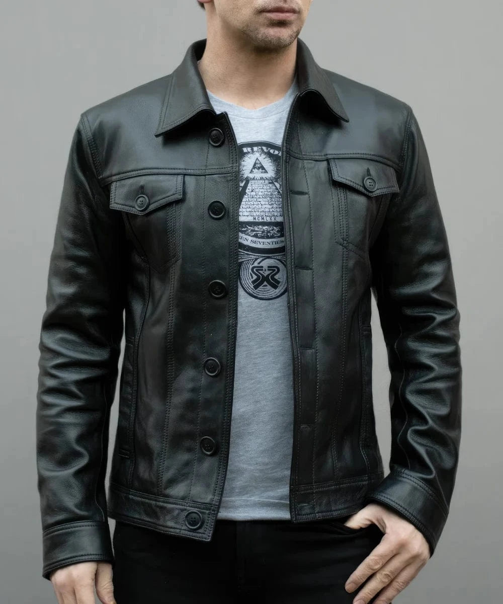 Model wearing vintage black leather trucker jacket with slim fit styling and classic trucker inspired design