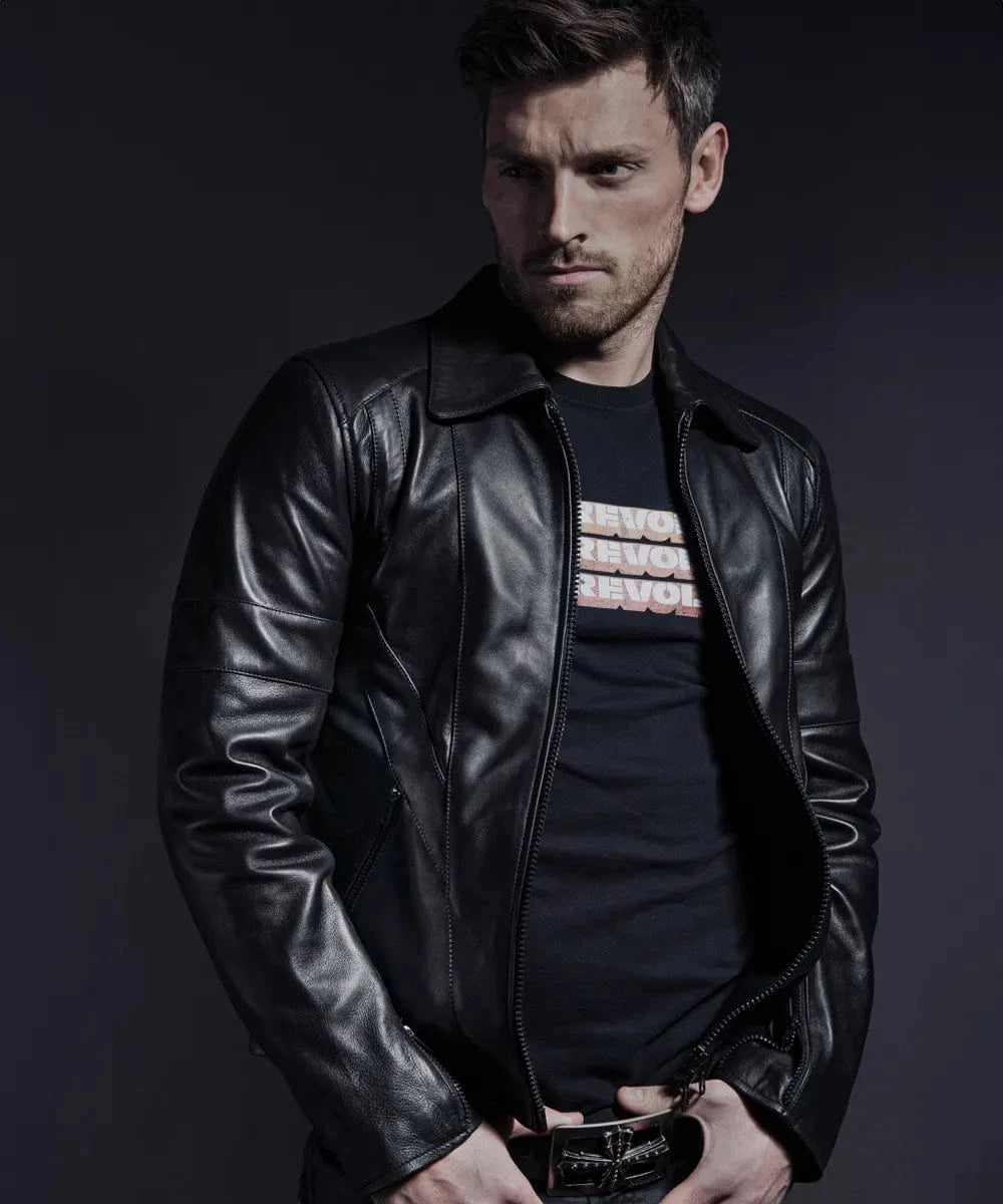Model wearing vintage black leather jacket with slim fit styling and zip front design